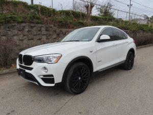 White Toyota Camry with professional car window tinting parked in Trussville.